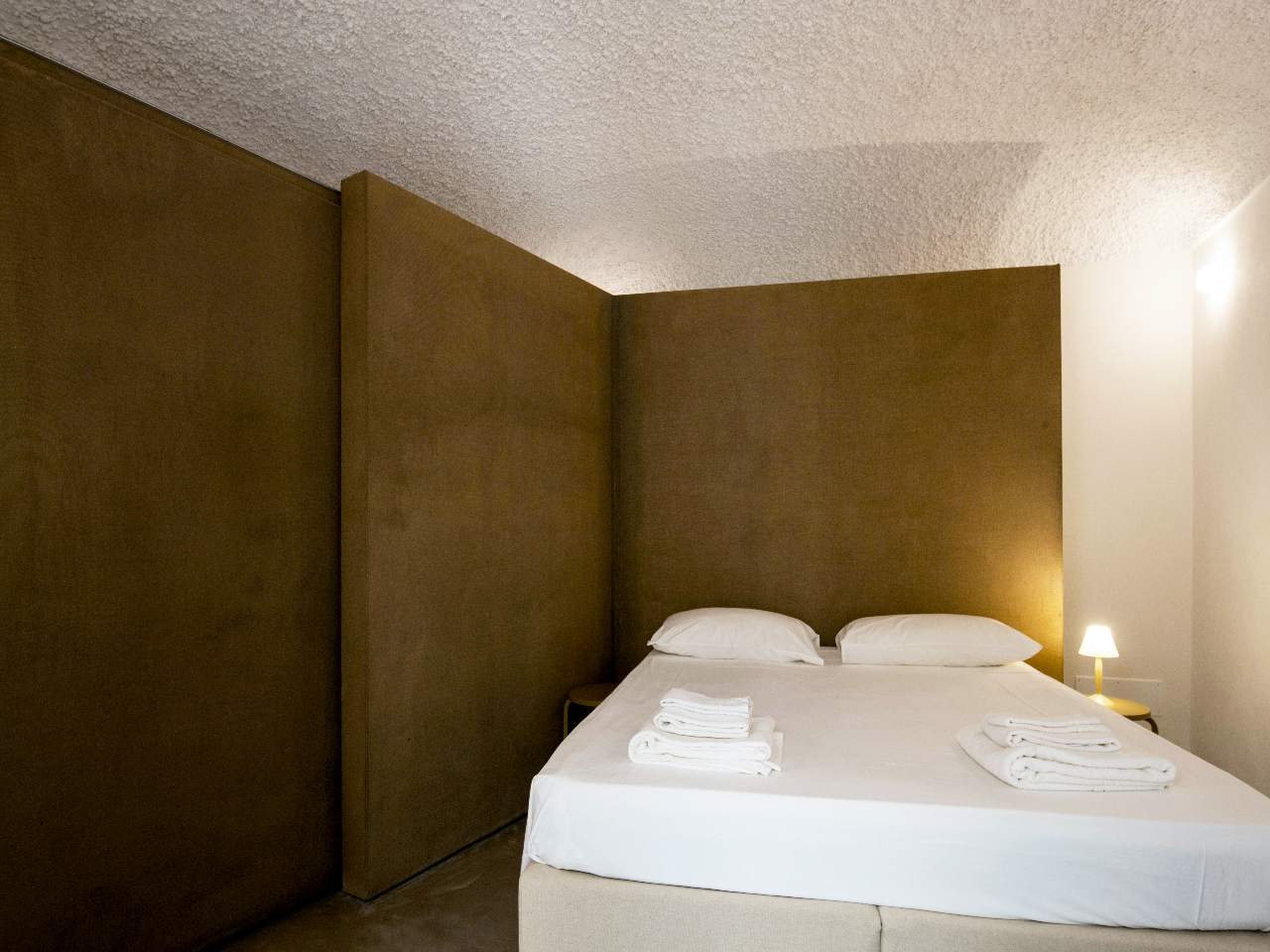Elegant double bedroom of the Aurea apartment in the heart of Ortigia