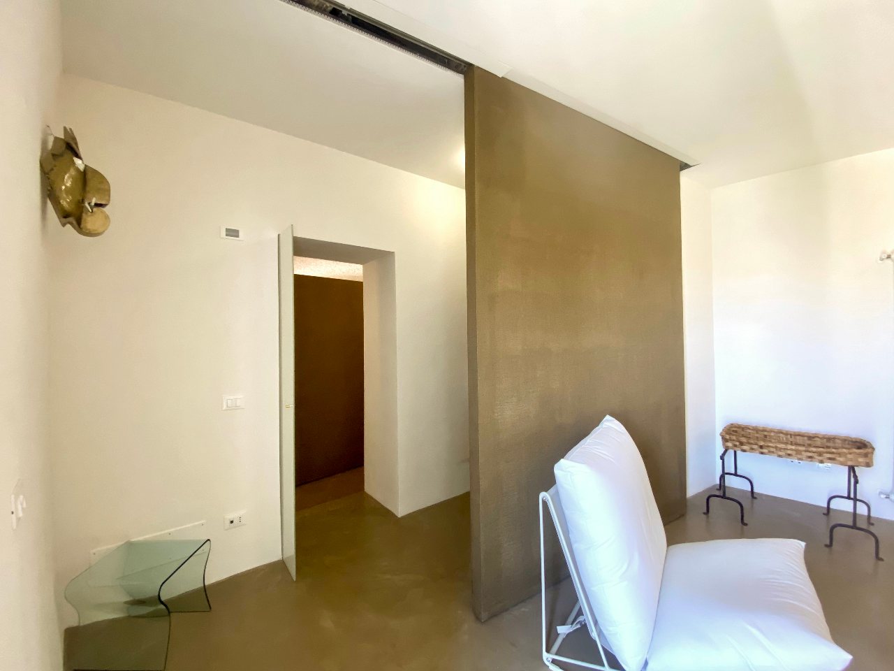 Cozy corner of the minimalist living room in Aurea apartment, Ortigia, Syracuse