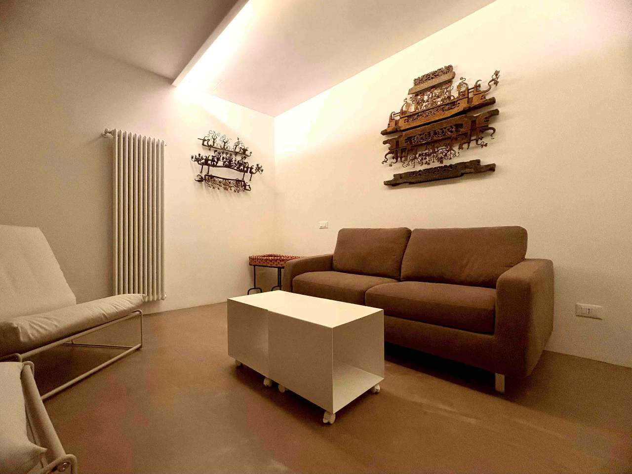 Bright interiors of the living room in Aurea apartment, heart of Ortigia
