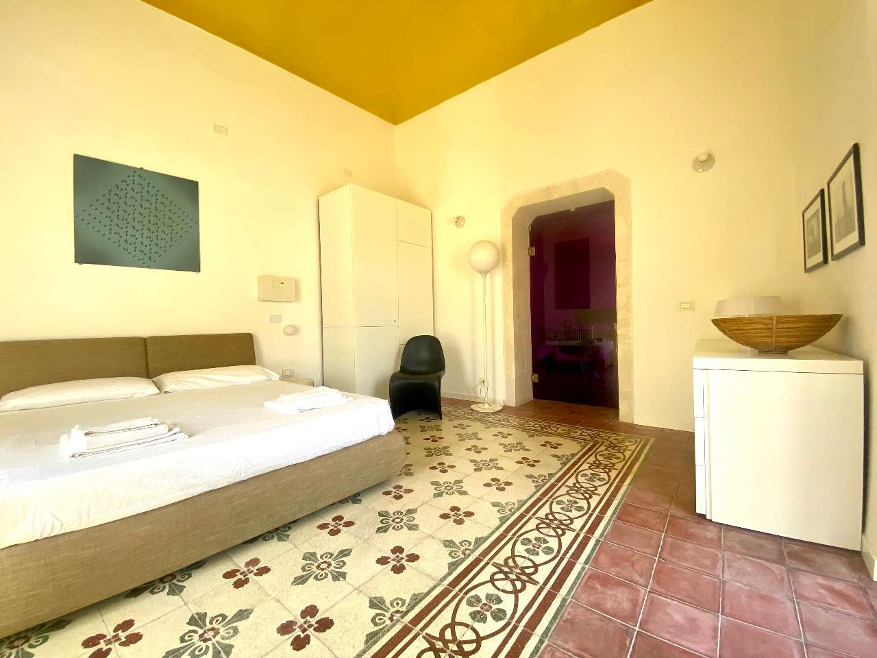 Cozy interiors of the double bedroom in Kleomene apartment, Ortigia, Syracuse