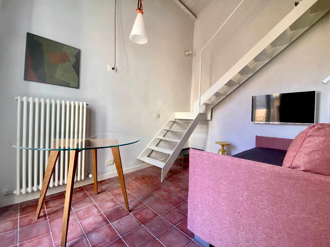 Bright loft bedroom with raised bed in Kleomene apartment, Ortigia