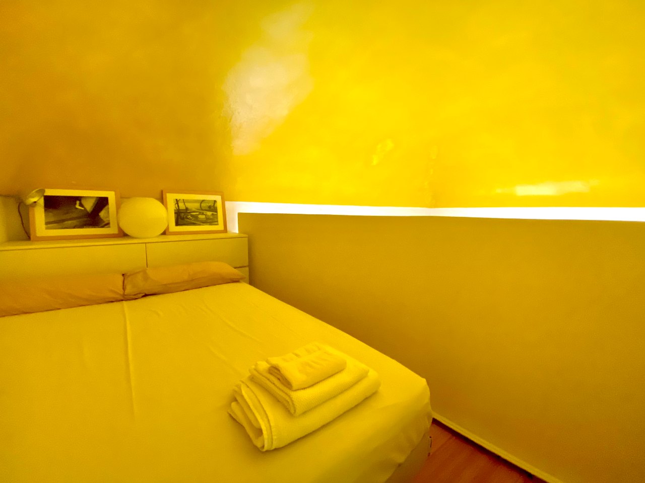 Cozy loft bedroom of the Kleomene apartment in Ortigia, Syracuse