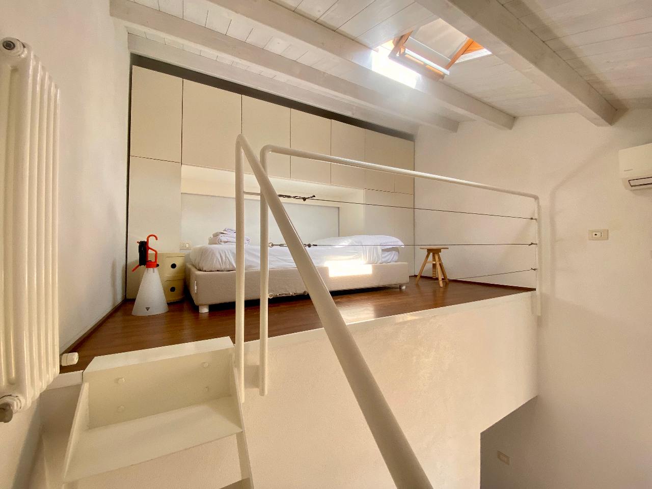 Elegant details of the loft bedroom of the Kleomene apartment, Ortigia