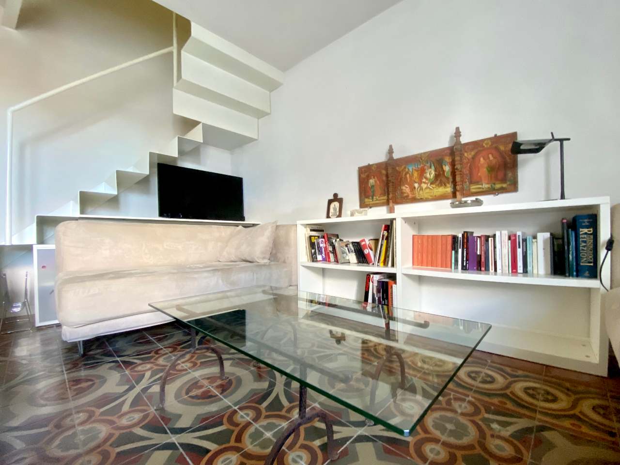 Loft bedroom with raised bed in Kleomene apartment, central Ortigia, Syracuse